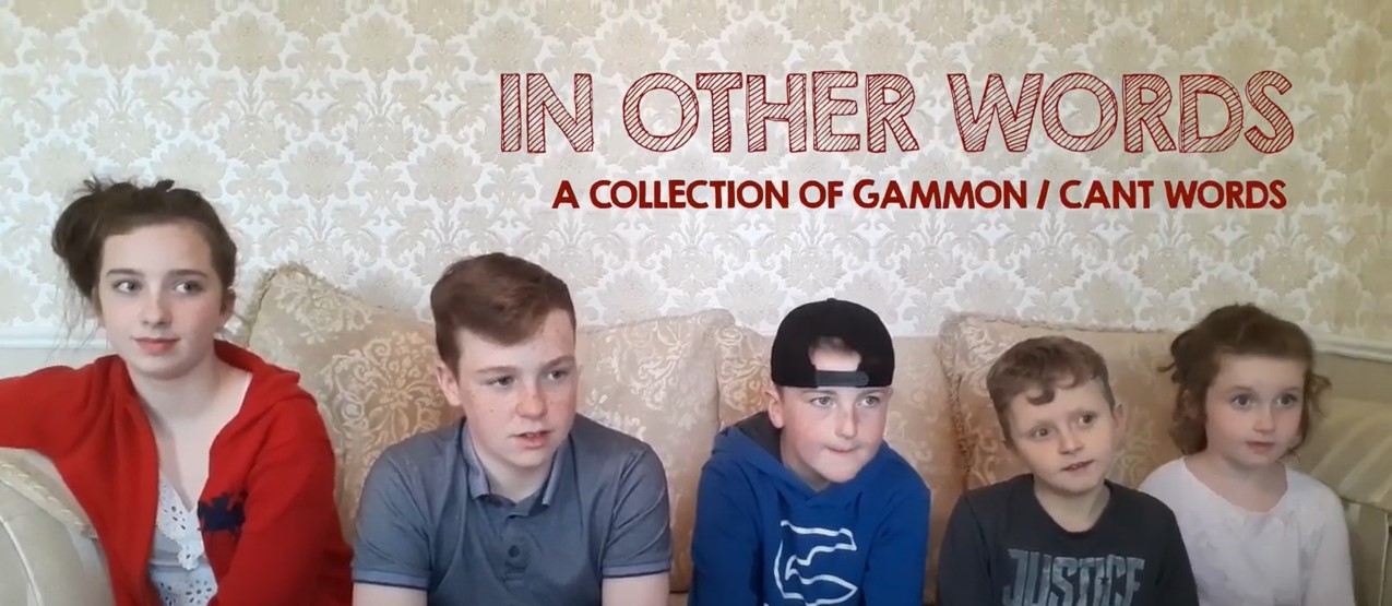 image from the video 2in other words" 5 children are sitting on a couch being interviewed.