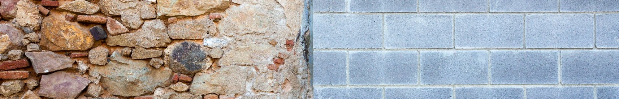 Photo of a wall divided in two. The left side is chaotically made of rocks and thin red bricks. The right is orderly grey concrete bricks.