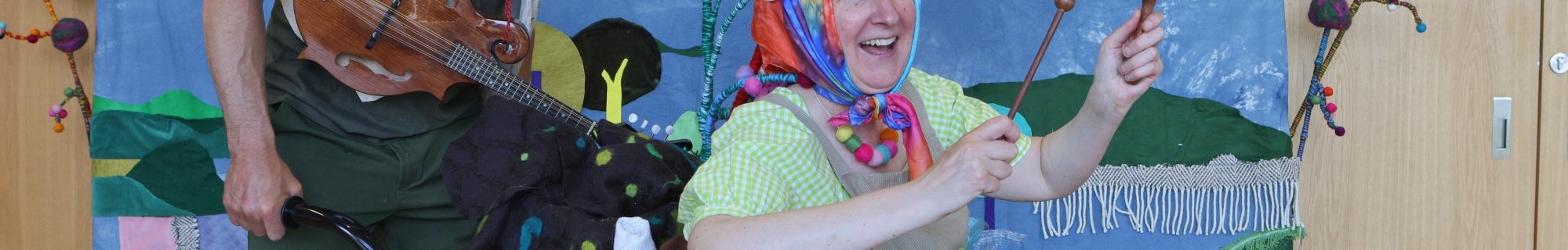 Photograph of performance for children, 2 artists in brightly coloured clothes