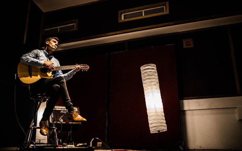 colour photograph of Chris Comhaill playing guitar