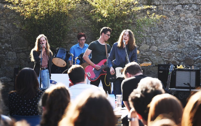 Image of band performing in front of audience 