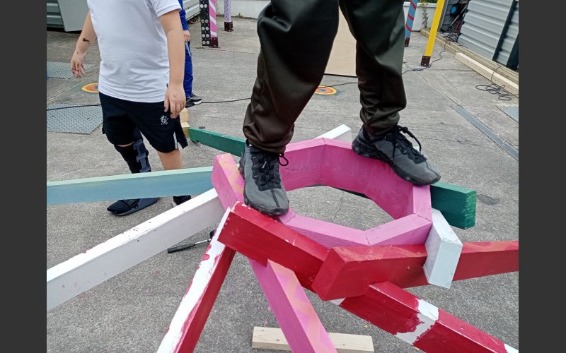 Image of young people testing the roof of the outdoor structure
