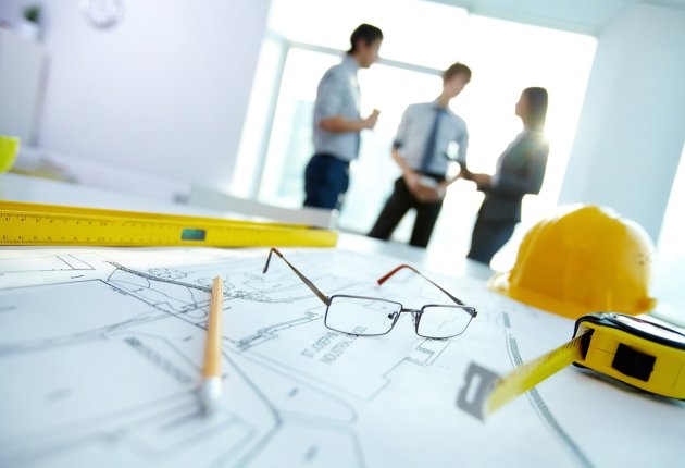 People meeting over house plans 
