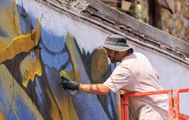 James Kirwan painting as part of Dún Laoghaire Anseo Street Art Festival 2022
