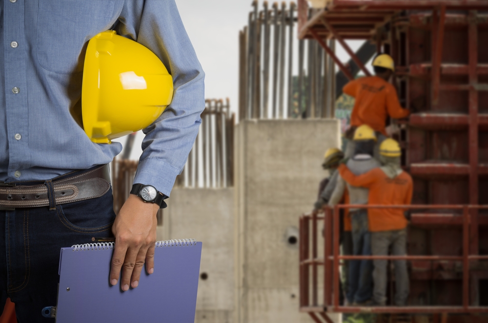 Inspector with hard hat at building site