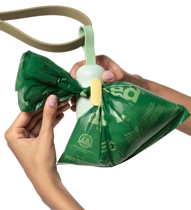 Earth Rated bag dispenser with doggie bag clipped on the bag for ease of transport