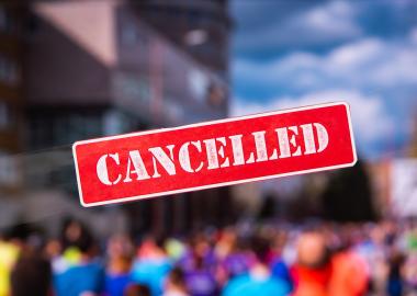 Cancelled sign with people in background