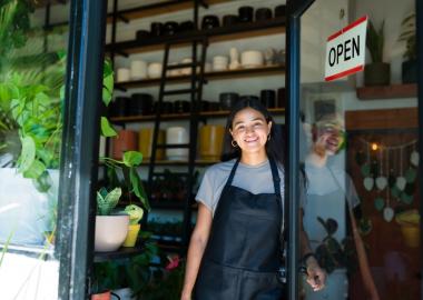 Woman at door with open sign