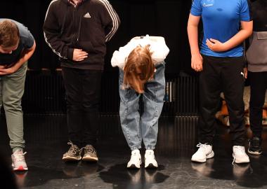 Young people in a black box theatre