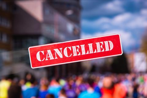 Cancelled sign with people in background