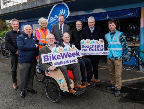 Group image with Cathaoirleach and Councillor on bike 