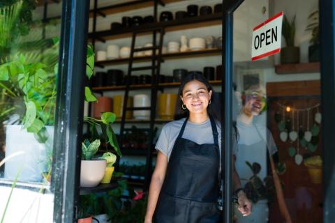 Woman at door with open sign