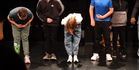 Young people in a black box theatre