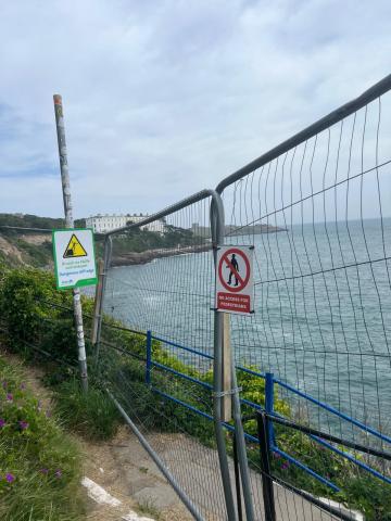 fencing with sea in background