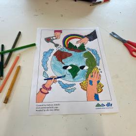 colouring pencils and a pair of scissors next to a coloured in drawing of planet earth with hands painting, cleaning and watering the earth
