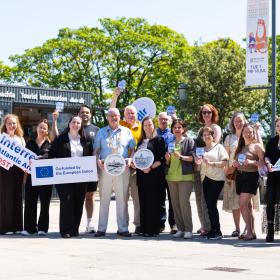 The Dún Laoghaire Passport launch with An Cathaoirleach, Councillor Jim Gildea at dlr, local business owners and dlr staff holding up plagues advertising the Dun Laoghaire passport.
