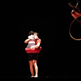 two people hugging in darkness