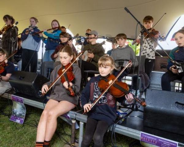 A group of young people playing traditional irish music