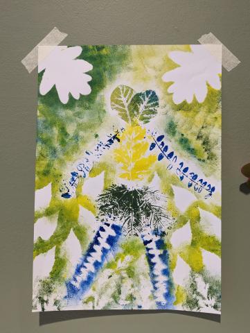 A colourful print depicting a two headed human made from leaves