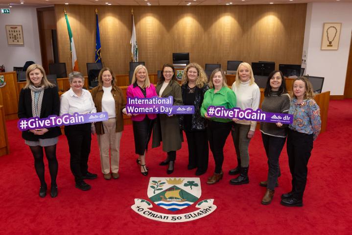 DLR Women's Committee members in the Council Chamber, holding placards for International Women's Day