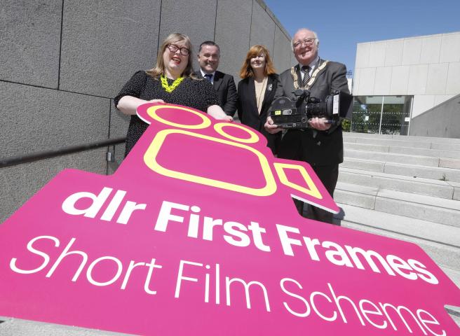 Vanessa Gildea, Aidan Blighe, Therese Langan, Cathaoirelach Councillor Denis O'Callaghan holding a bright pink logo with dlr First Frames Short Film Scheme written in white letters
