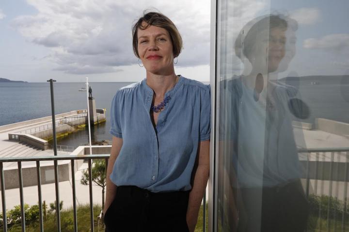 artist Seoidin O'Sullivan is standing in the window of the bath. Behind her you can see the jetty and the statue of Roger Casement. Photo by Mark Stedman