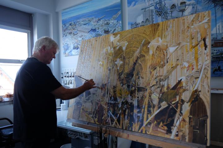 Dave Madigan photographed painting a large canvas in his studio