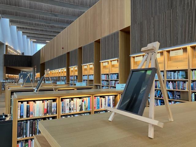 Framed photos on easels on top of bookshelves in the Lexicon Library.