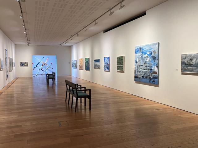 Photo of the gallery in the lexicon. Large paintings by Dave Madigan are on the walls.