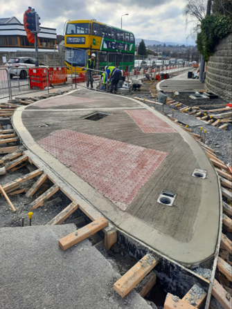 Pedestrian crossing island poured with retention sockets for traffic signal poles and tactiles in place
