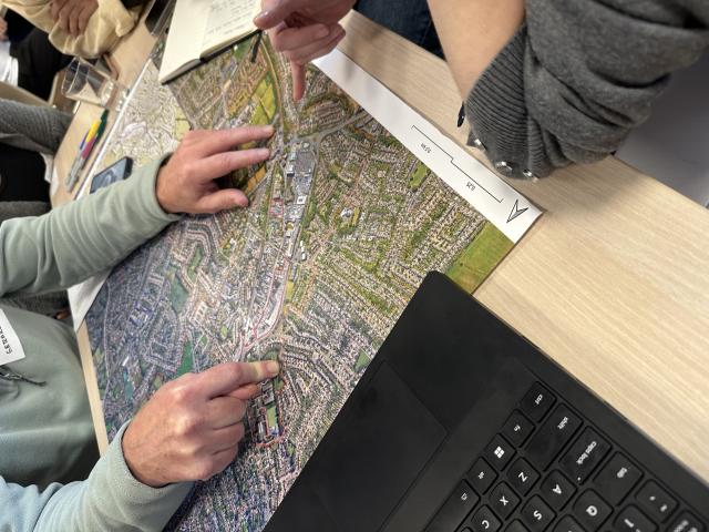 two people reading out dundrum area map for dundrum by design consultation  workshop