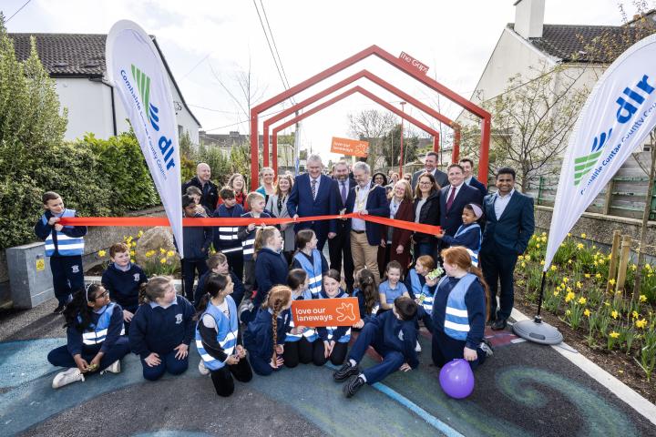 people gathered for a group picture holding signs