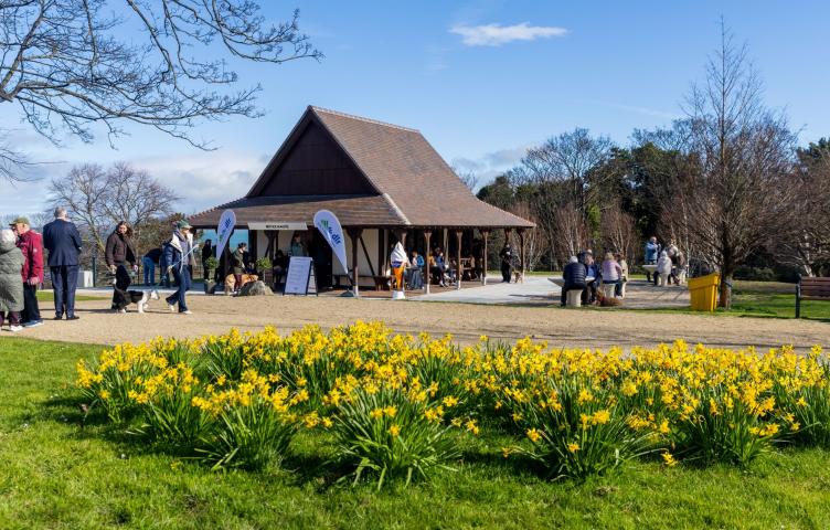 A picture of the Blackrock Tearooms with a blue sky and yellow flowers