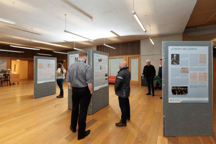 People looking at the Joseph McGrath and Thomas Cullen Exhibition