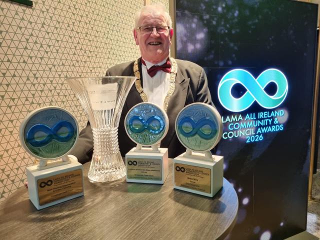 Cathaoirleach of DLR, standing in front of multiple awards