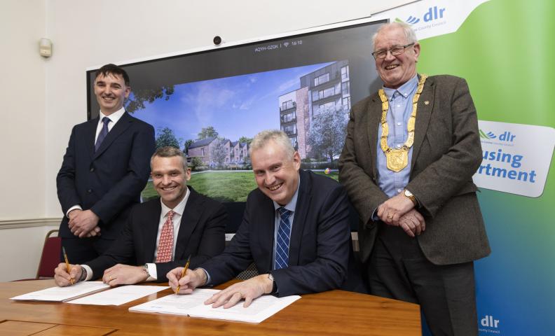 Four men signing contract