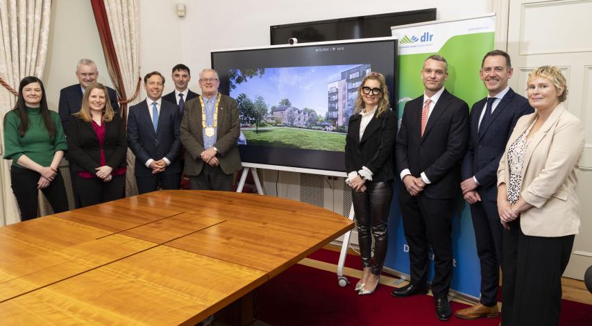 Group of people in front of digital screen