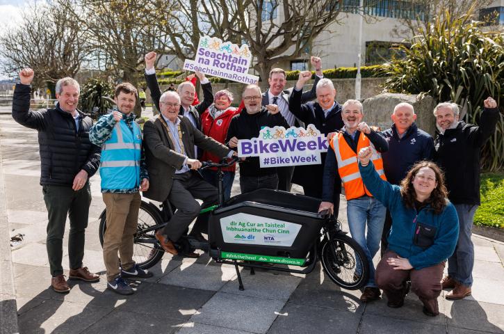 Group image with Cathaoirleach and Councillor on bike with Bike Week Advertisement