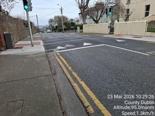 Street with green traffic light and stop sign.