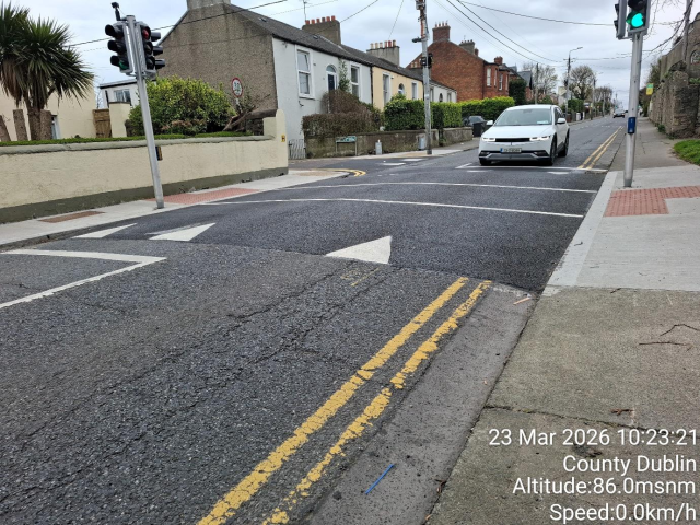 Street with green traffic light and stop sign.