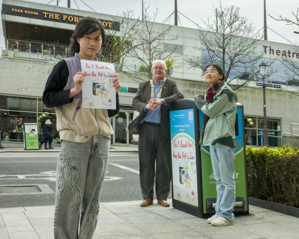 two girls in front of Big Belly Bin with Cllr Jim Gildea