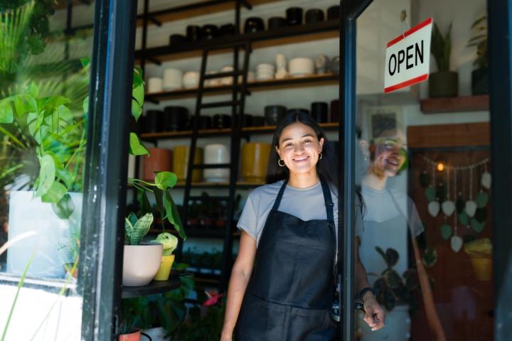 Woman at door with open sign