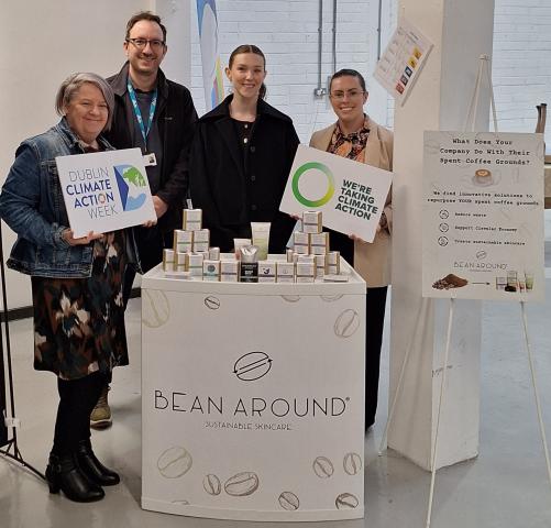 Four people standing together at an event, posing for a group photo.