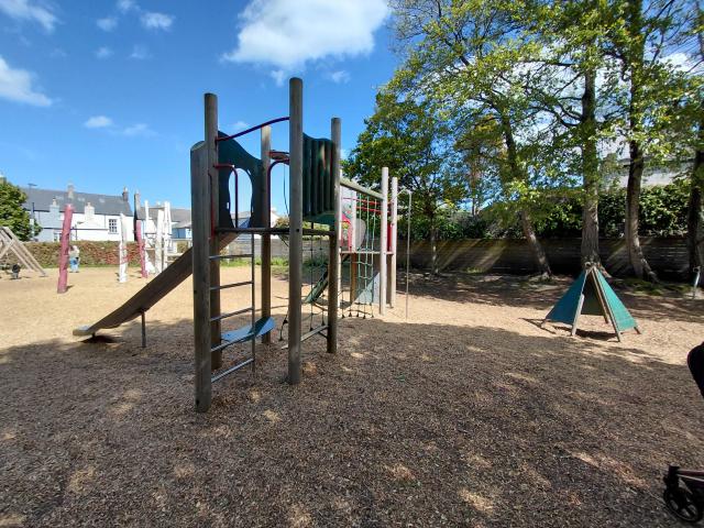 Image of a playground with a slide and monkey bars