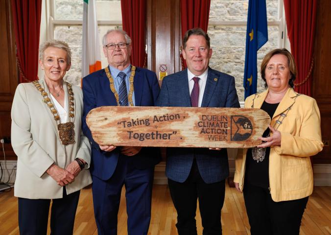 two women and two men holding climate action week sign