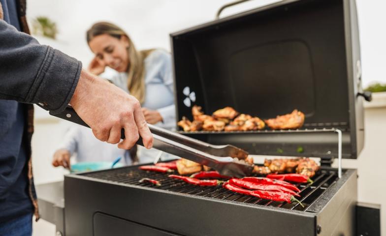 picture of BBQ with food and a man's hand