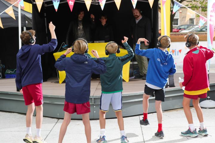 group of boys dancing in front ot stage