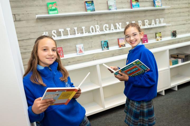School kid reading in new library
