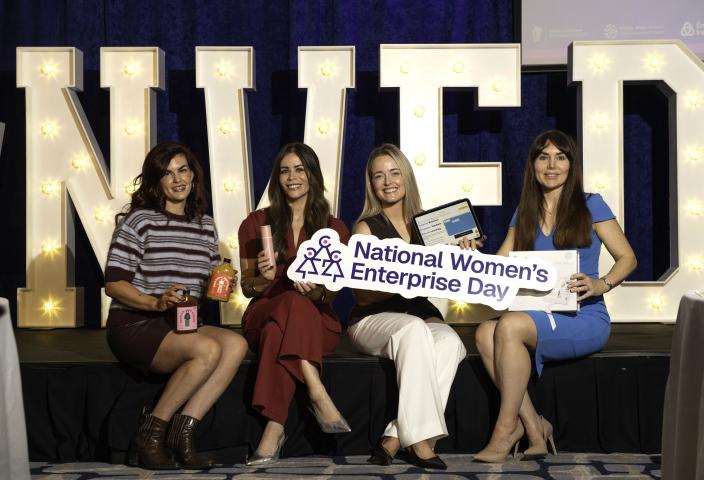four winners holding NWED banner