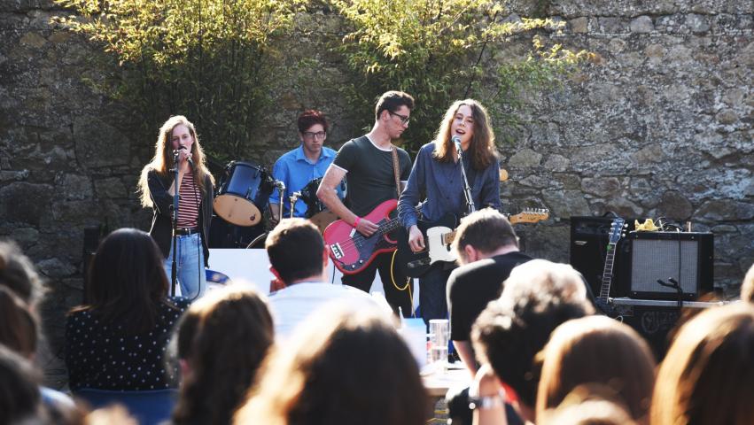 Image of band performing in front of audience